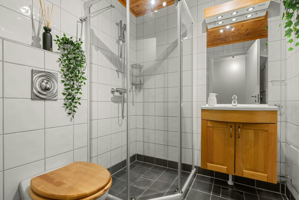 A bathroom with a toilet, sink, and shower